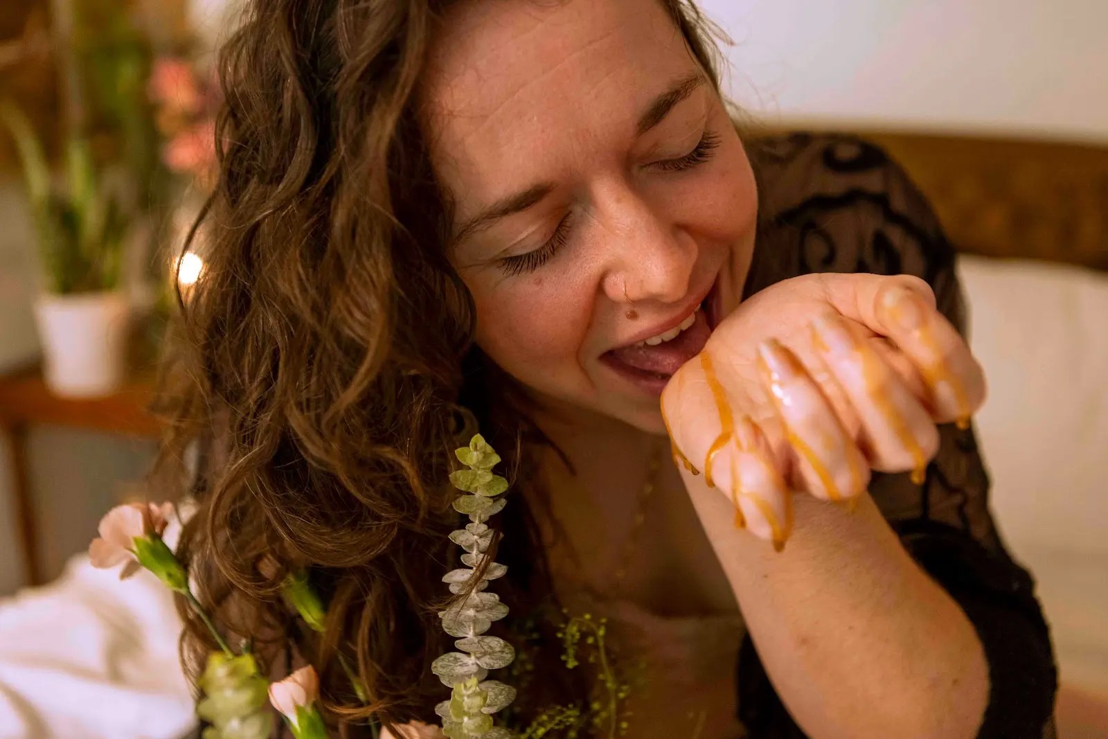 Honey tasting honey from her hand