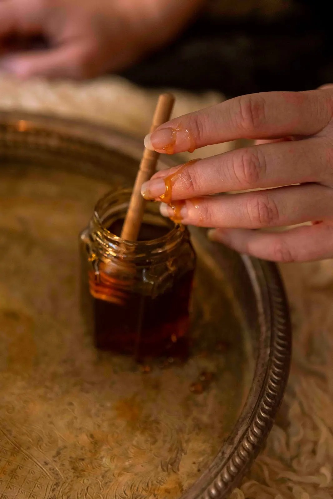 Honey being poured from a dipper