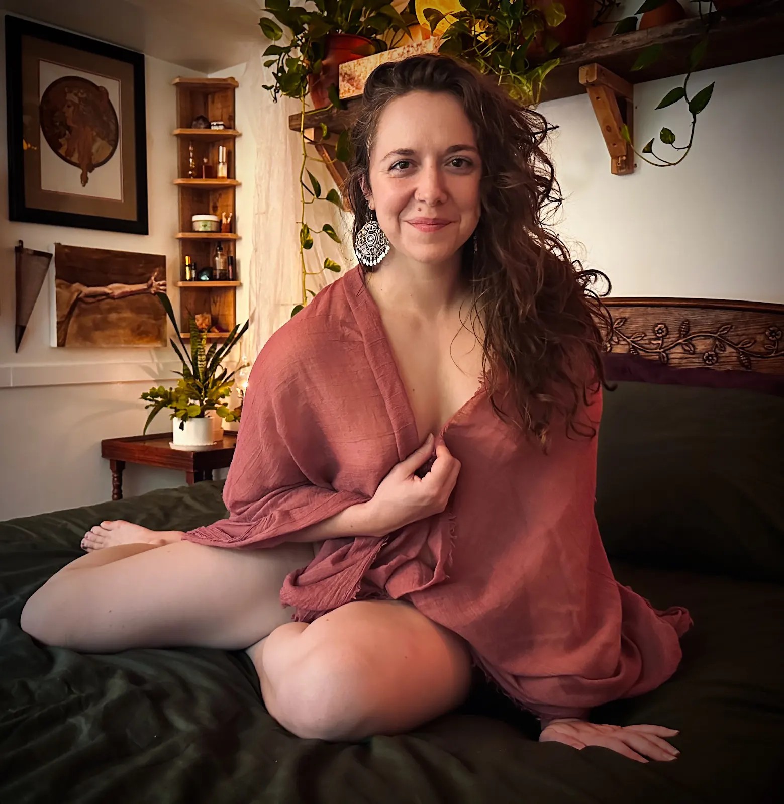 Honey sitting on her bed in a robe